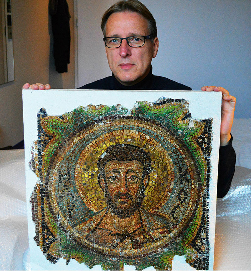 Dutch art detective Arthur Brand poses with the missing mosaic of St Mark, a rare piece of stolen Byzantine art from Cyprus, in a hotel room in The Hague on 17 November 2018. Photo: AFP