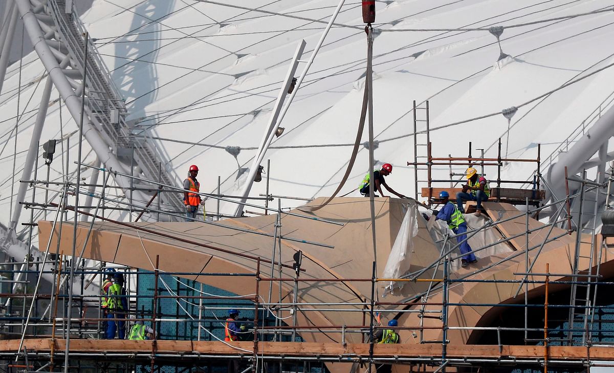 Workers are pictured on scaffolding at the Khalifa International Stadium on 18 November 2018, in Doha. Photo: AFP