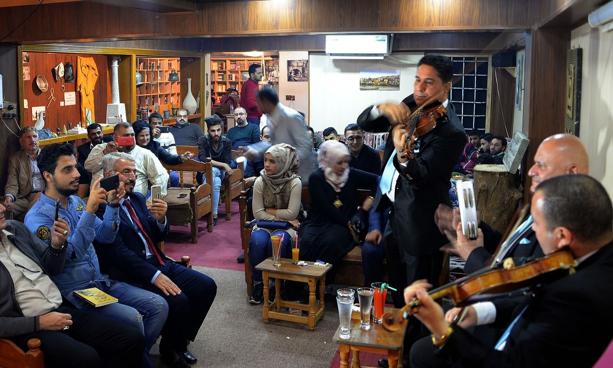 Iraqis listen to live music at a cafe in Iraq`s second city of Mosul on 2 November. Photo: AFP