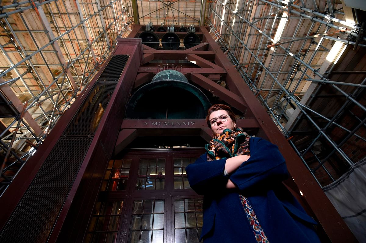 Polish carillon player Malgosia Fiebig poses for a picture below the bells of the Dom Tower (Domtoren) in Utrecht, the Netherlands` tallest church tower, on 8 November 2018. Photo: AFP