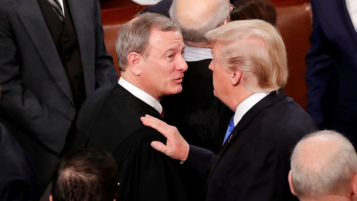 US president Donald Trump (R) talks with US Supreme Court chief justice John Roberts as he departs after delivering his State of the Union address to a joint session of the US Congress on Capitol Hill in Washington, US on 30 January 2018. Photo: Reuters