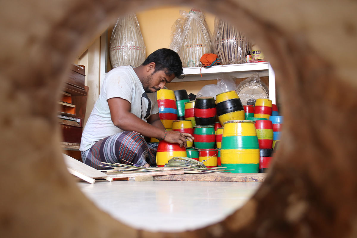 A worker is seen busy making drums at Sree Sree Lakshmi-Narayan Mandir Road, Khagrachhari on 20 November. The drums will be sold in the fair organised celebrating the Hindu festival of Ras in town on Thursday. Photo: Nerob Chowdhury