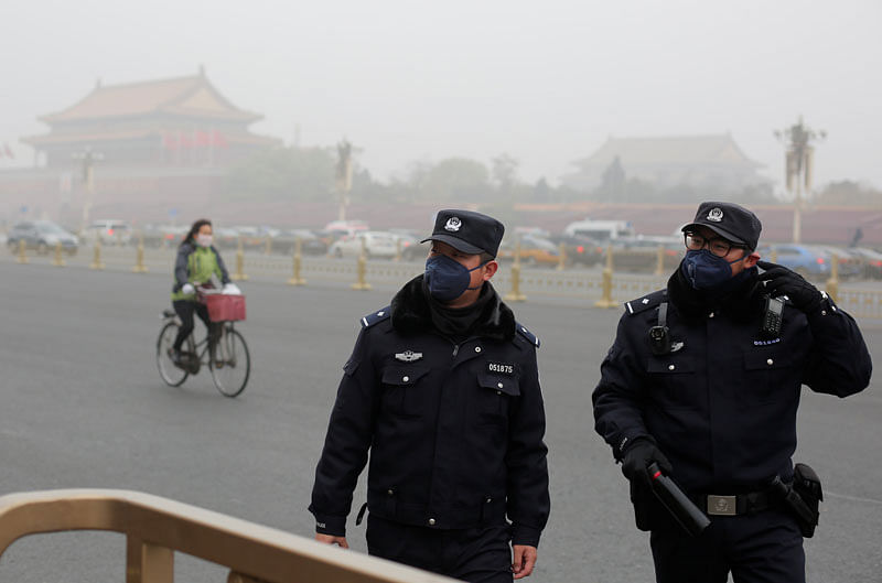 Police officers wear masks as Tiananmen Square is shrouded in haze after a yellow alert was issued for smog in Beijing, China, on 14 November 2018. Photo: Reuters