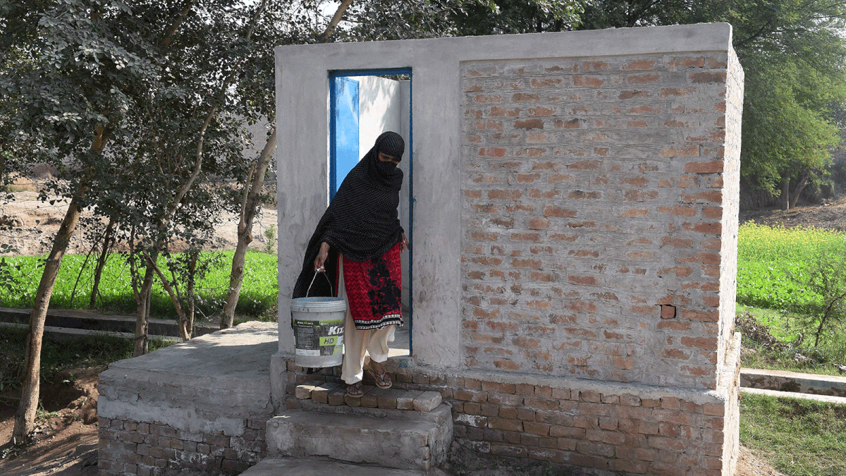 In this picture taken on 15 November 2018, a Pakistani woman comes out from a toilet in Basti Ameerwala village in central Punjab province. Photo: AFP 2. In this picture taken on 15 November 2018, a Pakistani woman pumps water from a hand pump next to a toilet in Basti Ameerwala village in central Punjab province. Photo: AFP