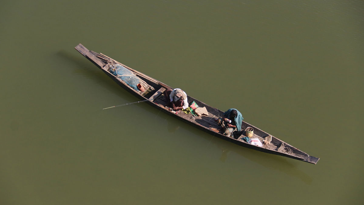Two fishermen on a boat angling with their hooks in river Surma in Sylhet on 24 November. Photo: Anis Mahmud