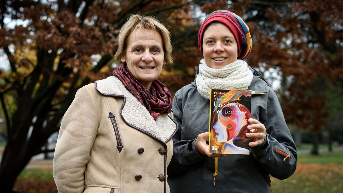 Geneva theology professors Elisabeth Parmentier (L) and Lauriane Savoy pose with an edition of `A Women`s Bible` on 20 November 2018 in Geneva. Tired of seeing their holy texts used to justify the subjugation of women, a group of feminist theologians from across the Protestant-Catholic divide have joined forces to draft `A Women`s Bible`. Photo: AFP