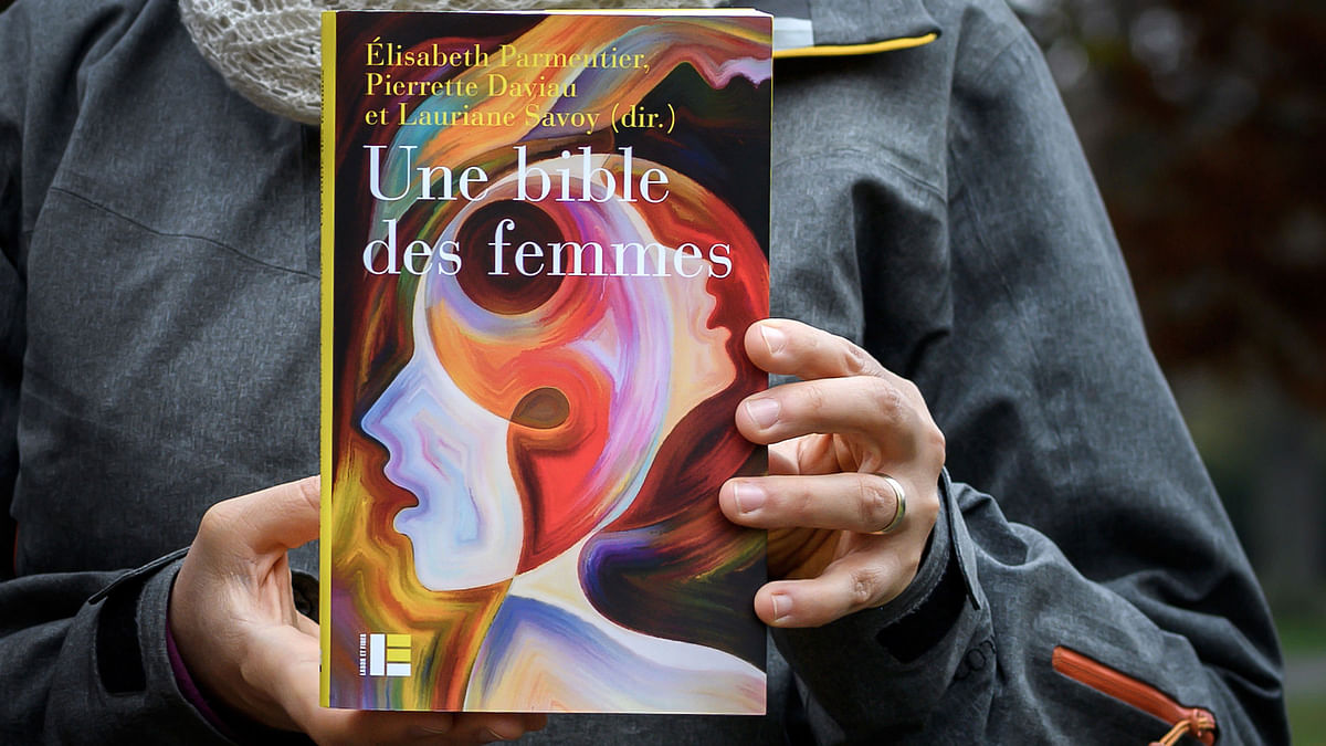 Geneva theology professor Lauriane Savoy holds an edition of `A Women`s Bible` on 20 November 2018 in Geneva. Tired of seeing their holy texts used to justify the subjugation of women, a group of feminist theologians from across the Protestant-Catholic divide have joined forces to draft `A Women`s Bible`. Photo: AFP