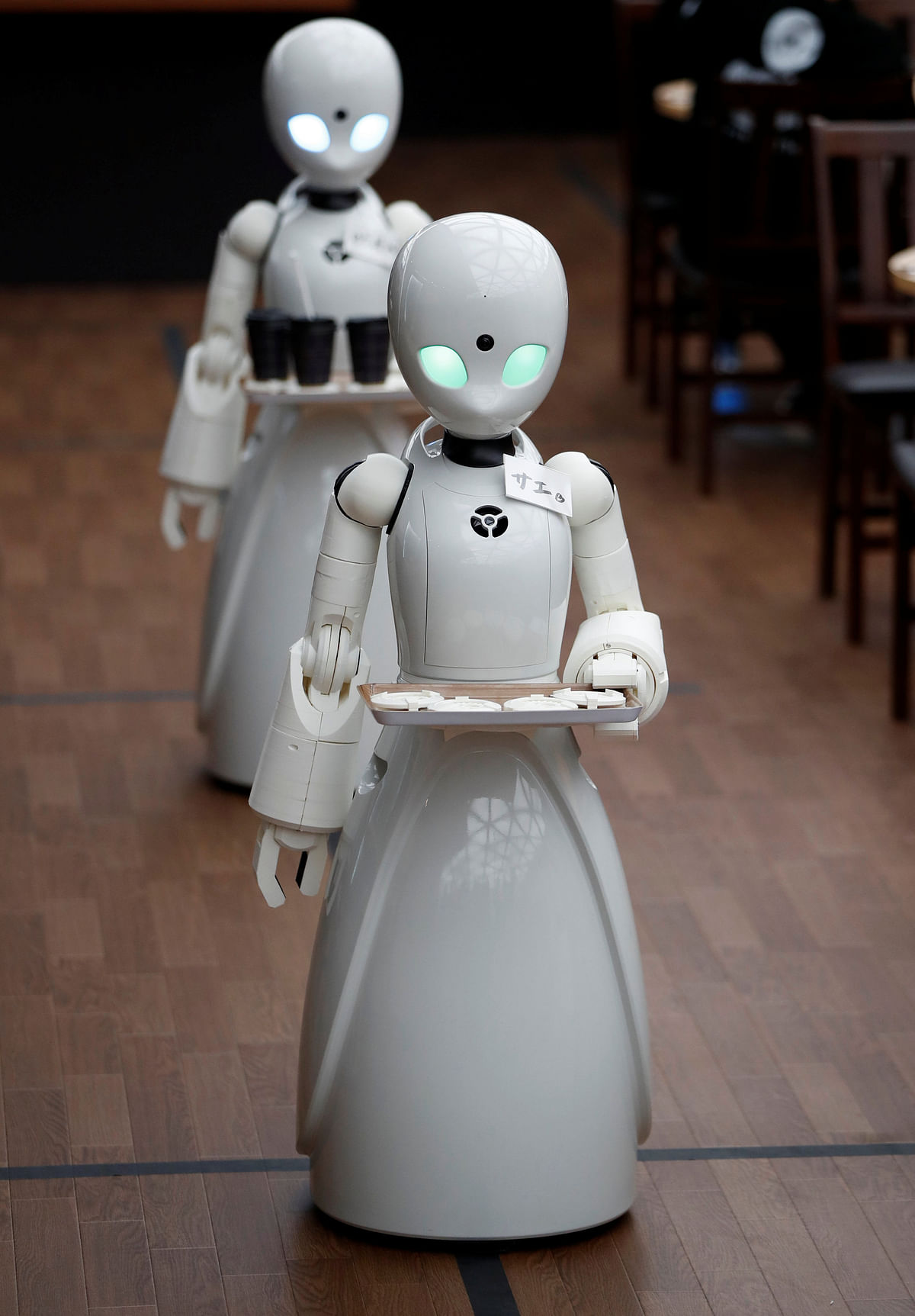 Remotely controlled robots OriHime-D, developed by Ory Lab Inc. to promote employment of disabled people, cuts a ribbon to celebrate the opening of a temporary cafe in Tokyo, Japan on 26 November 2018. Photo: Reuters