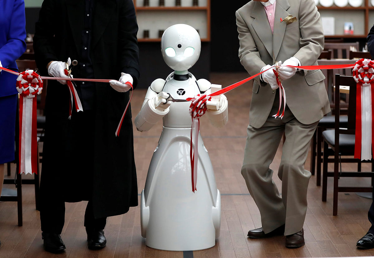 A remotely controlled robot OriHime-D, developed by Ory Lab to promote employment of disabled people, cuts a ribbon to celebrate the opening of a temporary cafe in Tokyo, Japan on 26 November 2018. Photo: Reuters