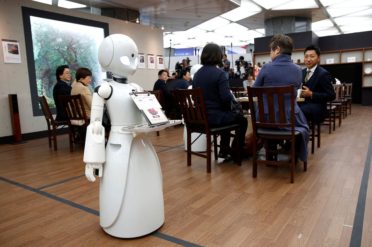 A remotely controlled robot OriHime-D, developed by Ory Lab to promote employment of disabled people, cuts a ribbon to celebrate the opening of a temporary cafe in Tokyo, Japan on 26 November 2018. Photo: Reuters