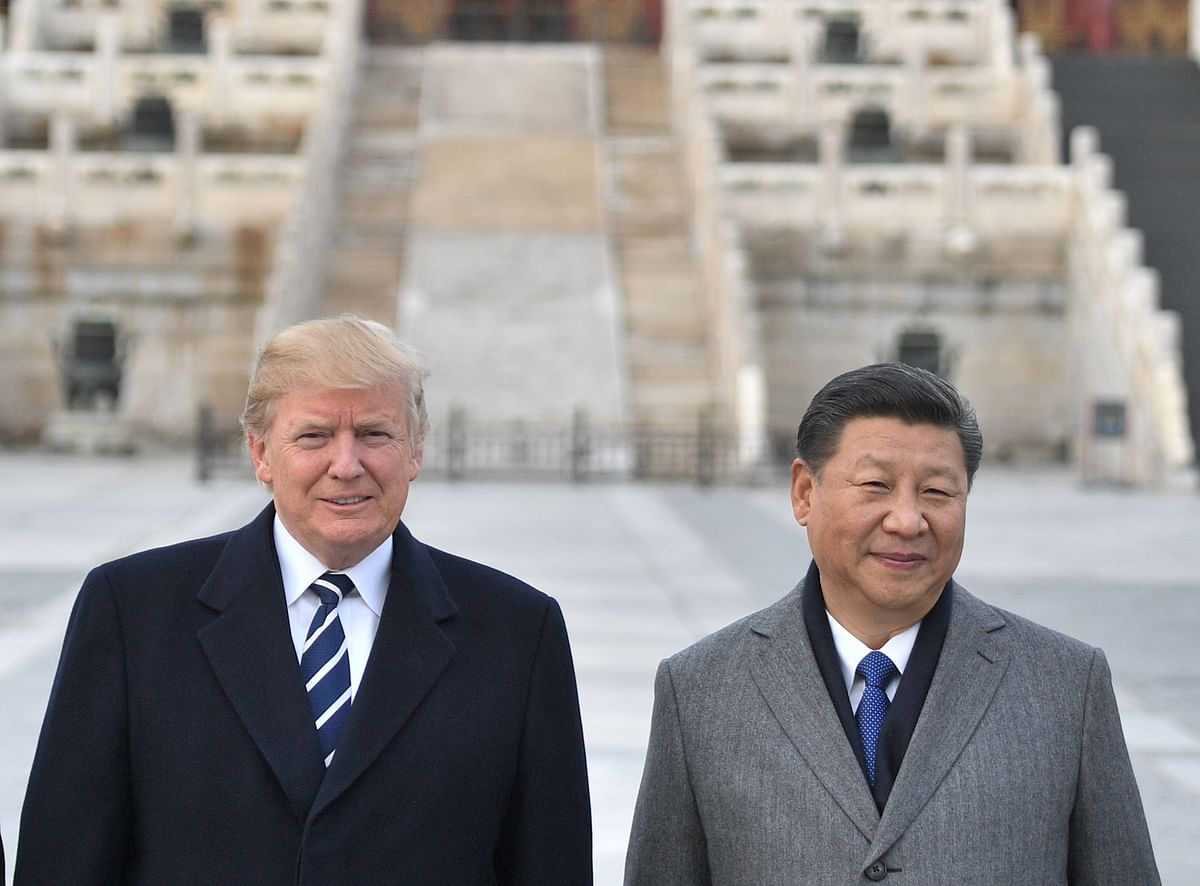 In this file photo taken on November 8, 2017, US President Donald Trump, and Chinese President Xi Jinping pose at the Forbidden City in Beijing.