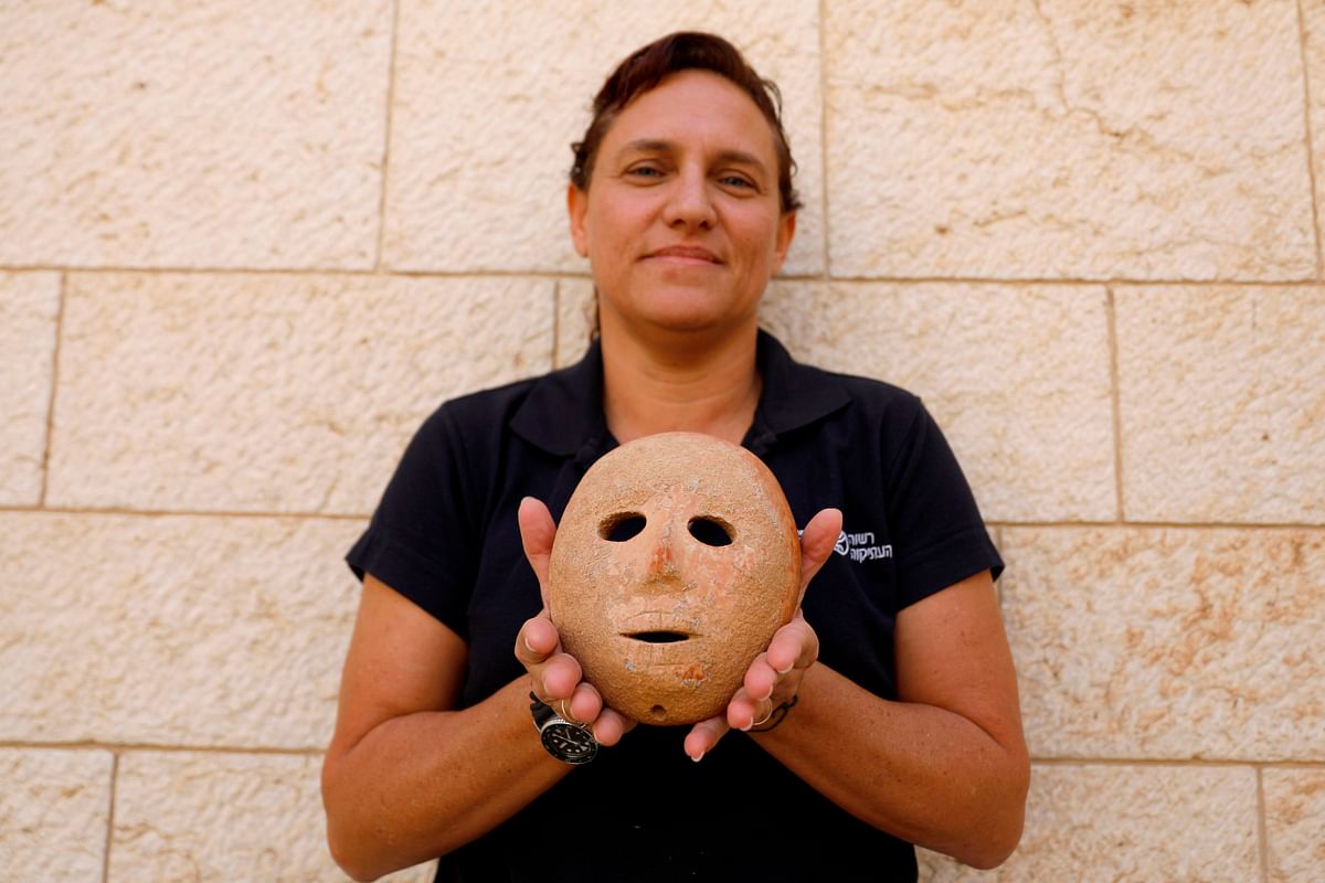 Israeli archeologist Ronit Lupu of the IAA Antiquities Theft Prevention Unit holds a rare stone mask dating to the Neolithic (new stone age) period which was found at the Pnei Hever region of southern Hebron mount, on 28 November 2018 at the Rockefeller archeological museum in Jerusalem. Photo: AFP
