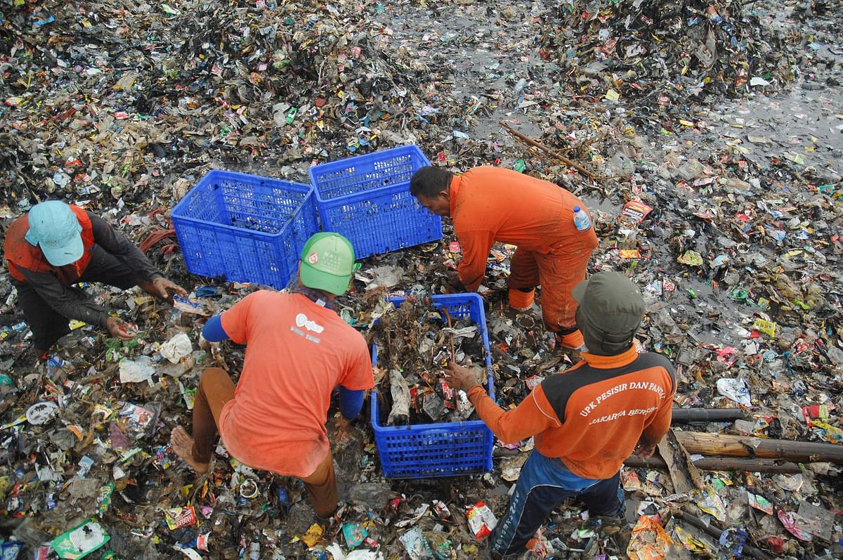 In this picture taken on 17 March 2018 workers clear up garbage piling up in Jakarta Bay area as part of the earliest local government combat against waste on its waters. Residents living on a string of coral-fringed islands to the north of Jakarta’s coast are battling a tidal wave of trash, with more than 40 tonnes of rubbish picked up daily over the past week. Photo: AFP