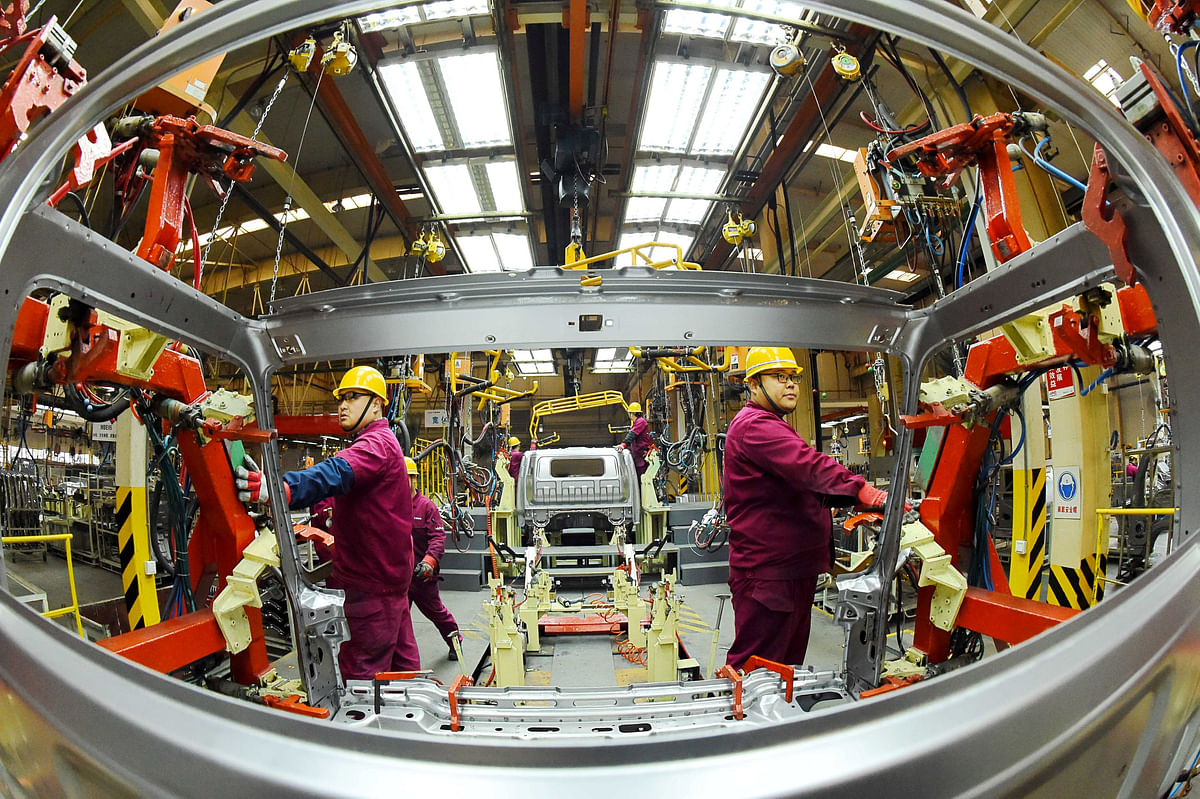 Employees work on a production line manufacturing light trucks at a JAC Motors plant in Weifang, Shandong province, China on 30 November 2018. Photo: Reuters