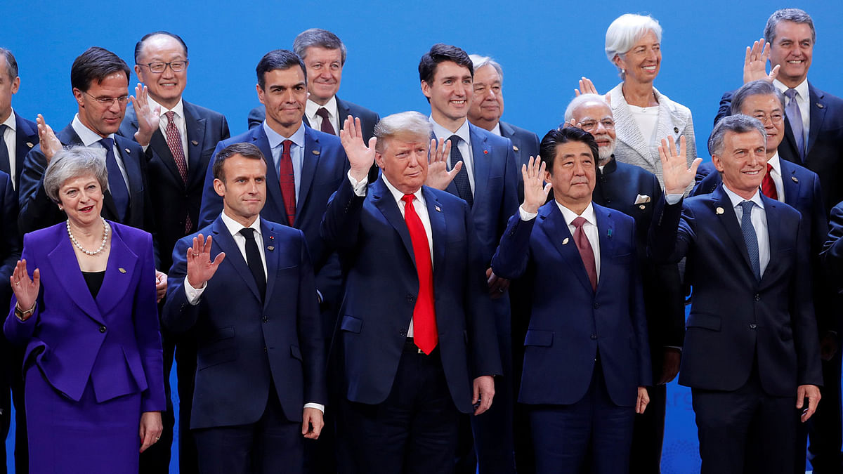 US president Donald Trump, Britain`s prime minister Theresa May, French president Emmanuel Macron and Japanese prime minister Shinzo Abe wave hands during a family photo at the G20 leaders summit in Buenos Aires, Argentina on 30 November. Photo: Reuters