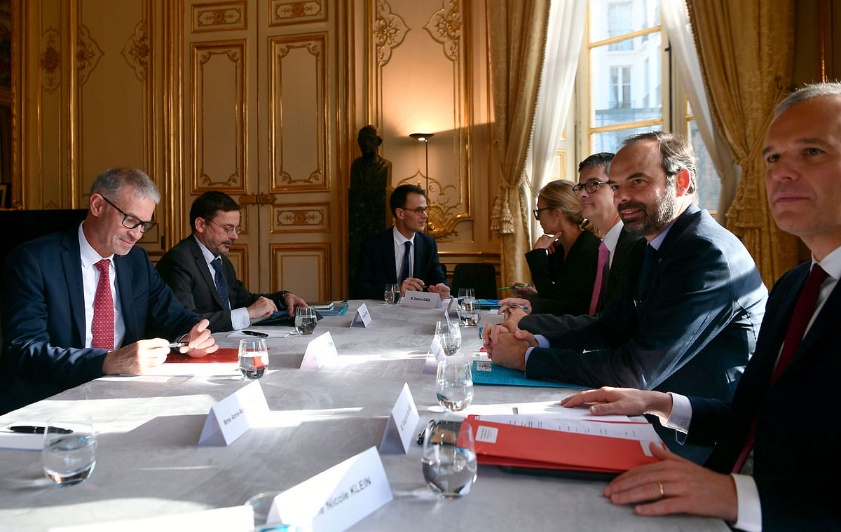 French prime minister Edouard Philippe (2ndR) and French minister for the ecological and inclusive transition Francois de Rugy (R) meet with Patrick Bernasconi (L), president of the Economic, Social and Environmental Council and member of the National Council for Ecological Transition (Conseil National de la Transition Ecologique - CNTE) at the Hotel Matignon in Paris on 30 November 2018. -- Photo: AFP