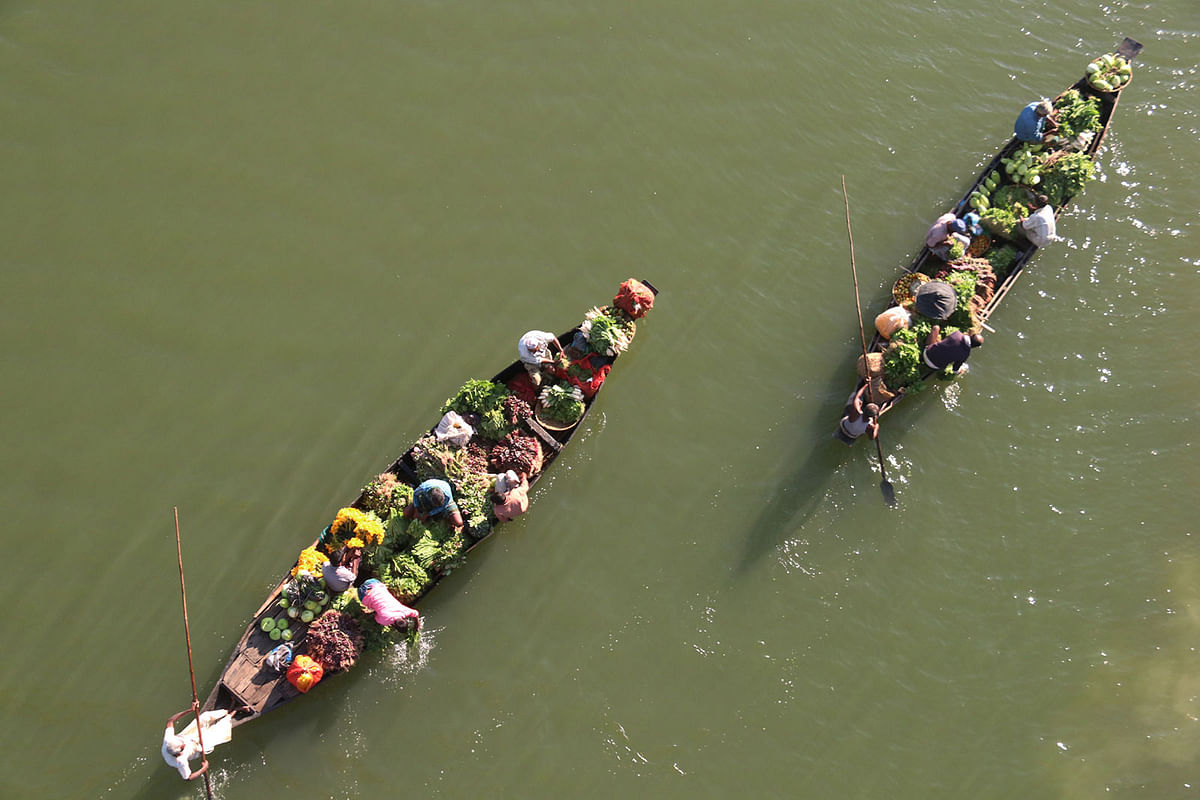 Farmers carrying vegetables by boat from Tuker Bazar to Sylhet on 1 December. Vegetables grow abundantly in winter in Tuker Bazar and farmers prefer the waterway due to a lower transport cost. Photo: Anis Mahmud