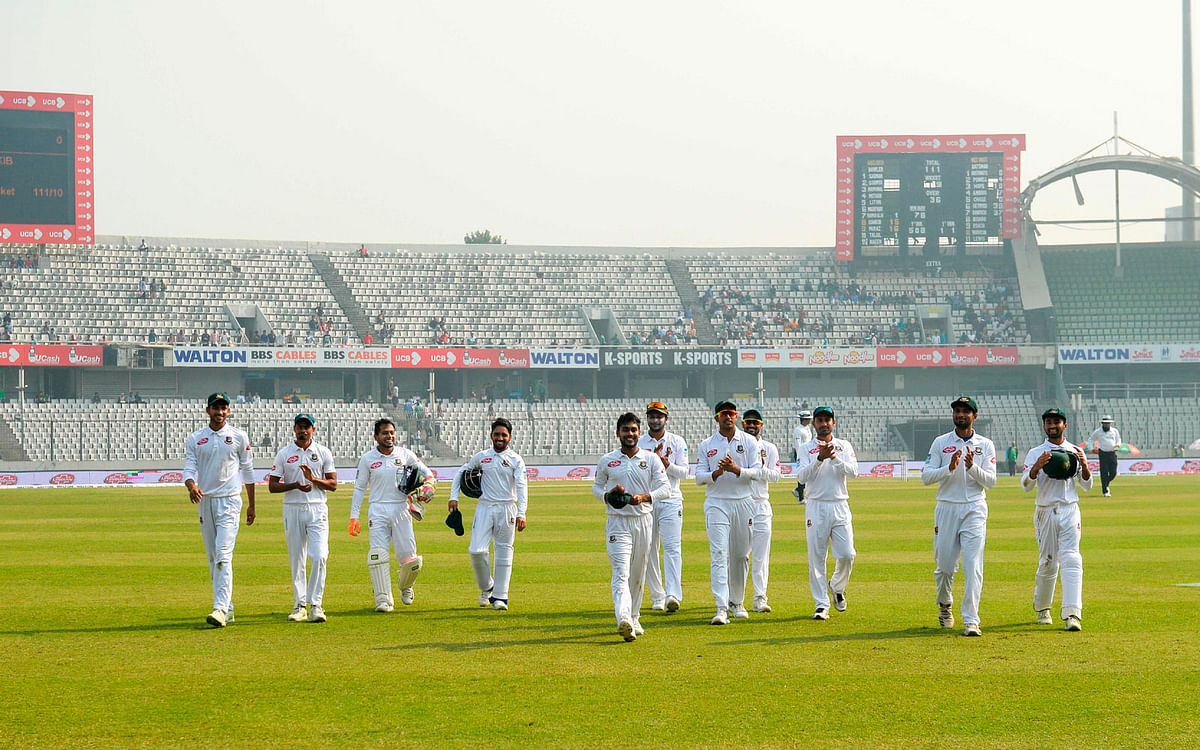 Bangladesh cricketers acknowledges teammate Mehidy Hasan (4th L) as he take six wickets during the third day of the second Test cricket against visiting West Indies at the Sher-e-Bangla National Cricket Stadium in Dhaka on 2 December 2018. Photo: AFP
