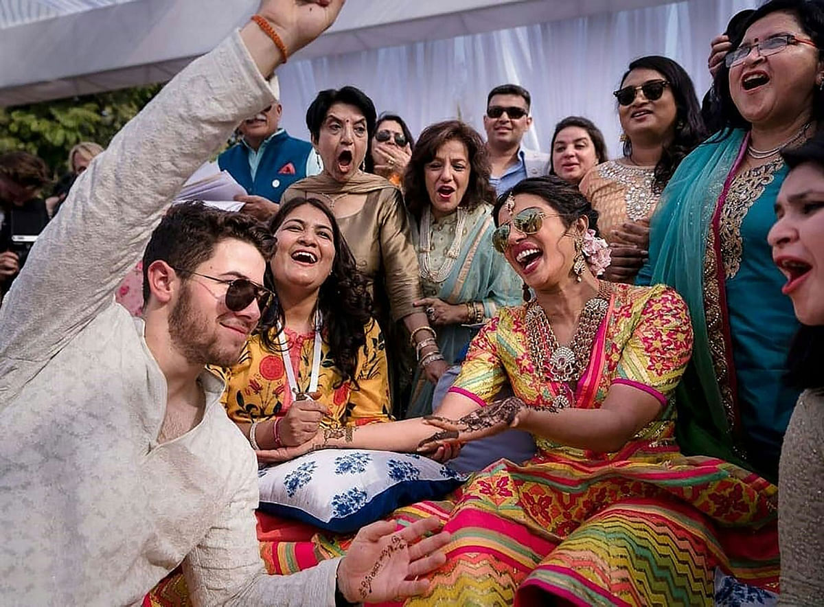 This handout photo released by Raindrop Media on 1 December 2018 shows Bollywood actress Priyanka Chopra (center R) and American singer Nick Jonas (L) during their wedding celebration along with friends and relatives at Umaid Bhawan palace in Jodhpur. Photo: AFP