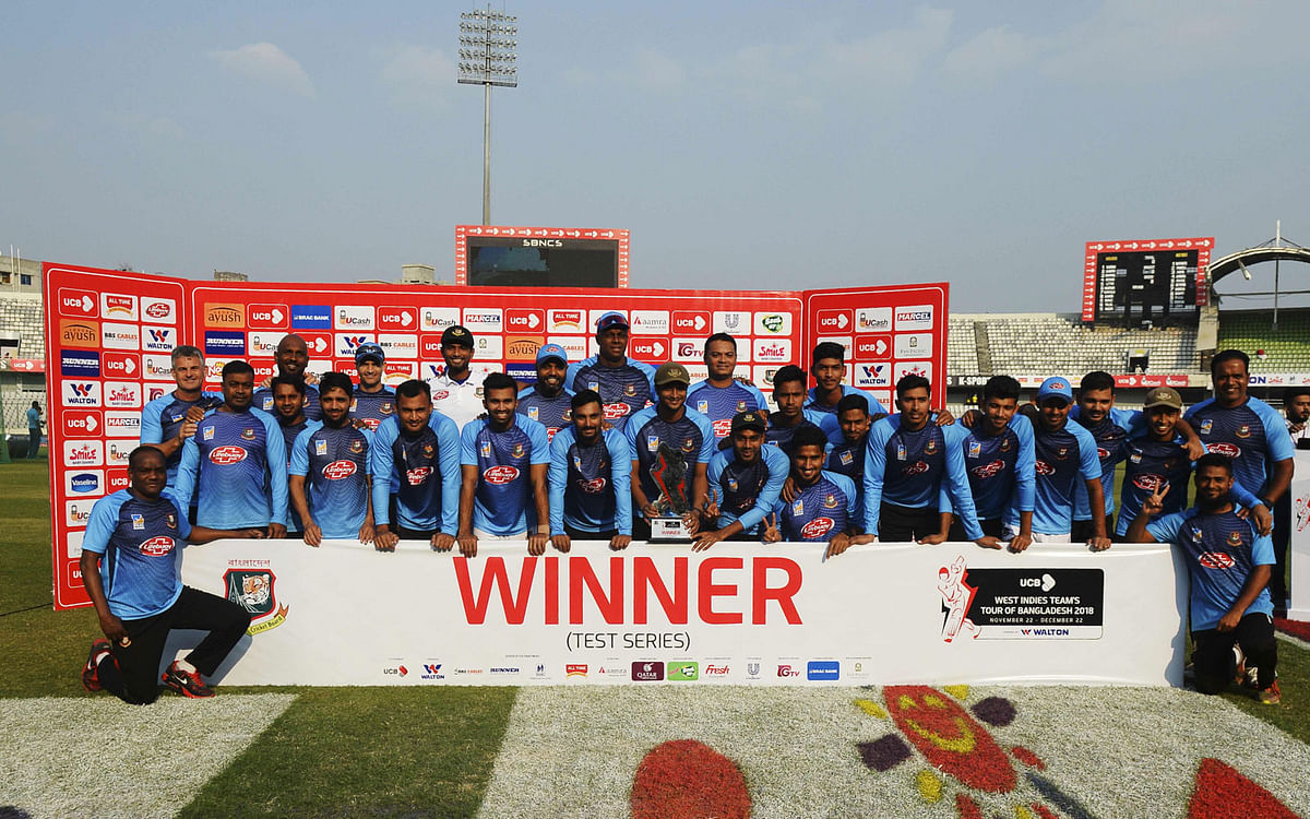 Bangladeshi cricketers pose with the tournament trophy following a presentation ceremony at the end of the second Test match at Dhaka on 2 December 2018. Photo: AFP