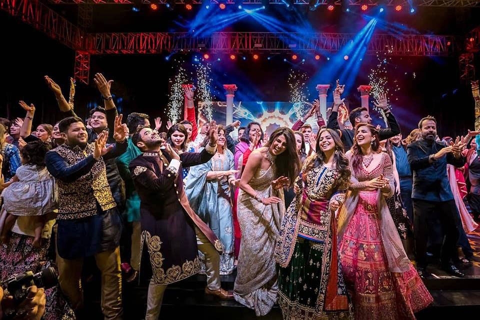 Bollywood actress Priyanka Chopra (R) and American singer Nick Jonas with guests during their wedding celebration at Umaid Bhawan palace in Jodhpur. Photo: Collected