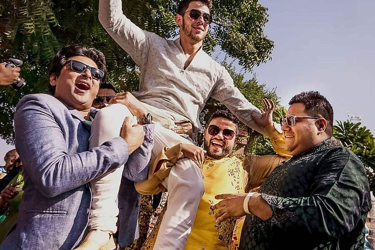 This handout photo released by Raindrop Media on 1 December 2018 shows dancing American singer Nick Jonas being carried by friends during his wedding celebration at Umaid Bhawan palace in Jodhpur. Photo: AFP