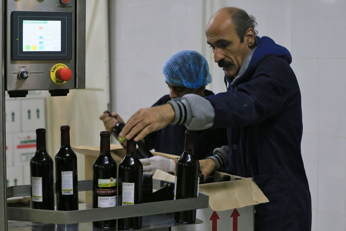 A picture taken on 5 November 2018, shows a worker inspecting bottles at the Saint George winery in Zahab, an eastern suburb of Amman. Two Jordanian families aim to put wine from their desert land on the world viticultural map, reviving an age-old tradition that some suggest has Biblical heritage. Wine lovers like to say that the wine Jesus Christ served to his disciples at the Last Supper came from the northern town of Umm Qais in modern-day Jordan, to signify how old the country`s winemaking tradition is. -- Photo: AFP