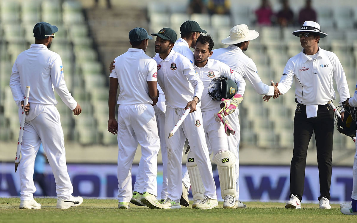 Bangladeshi cricketers celebrate their win at the end of the second Test match against visiting West Indies at Dhaka on 2 December 2018. Photo: AFP