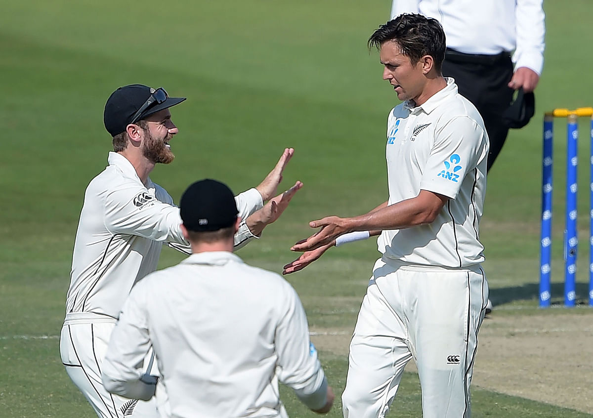 New Zealand bowler Trent Boult (R) celebrates with captain Kane Williamson (L) after taking the wicket of Pakistan batsman Imam-ul-Haq during the second day of the third and final Test cricket match between Pakistan and New Zealand at the Sheikh Zayed International Cricket Stadium in Abu Dhabi on 4 December 2018. Photo: AFP