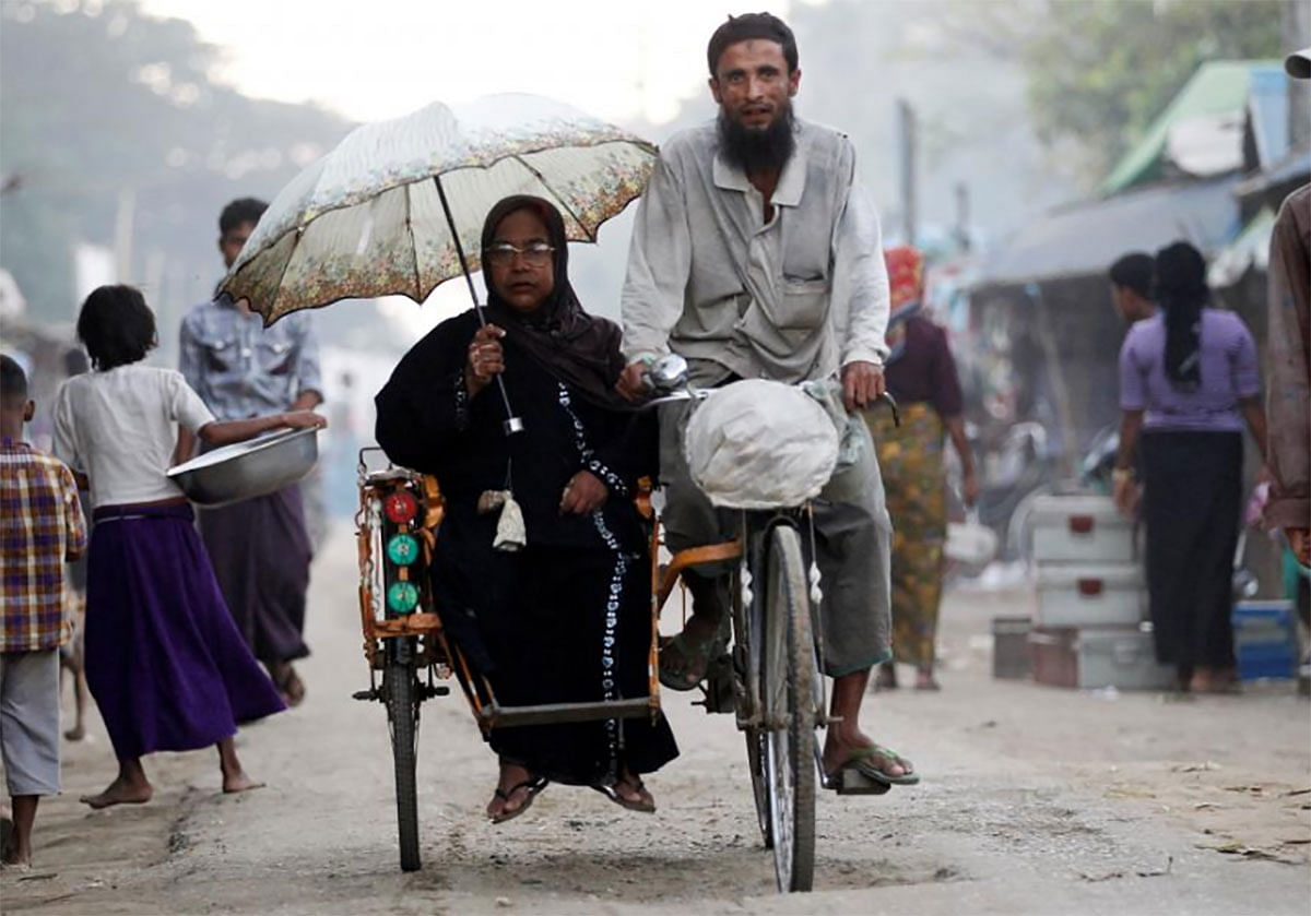 People ride a tricycle at a internally displaced persons camp for Rohingya people outside Sittwe in the state of Rakhine, Myanmar on 15 November 2016. -- Photo: Reuters