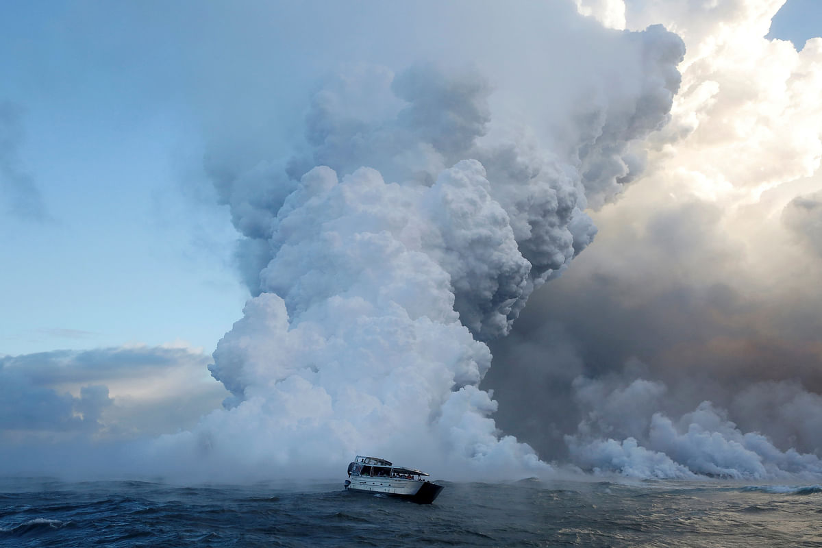 People watch from a tour boat as lava flows into the Pacific Ocean in the Kapoho area, east of Pahoa, during ongoing eruptions of the Kilauea Volcano in Hawaii, US, 4 June 2018. Photo: Reuters