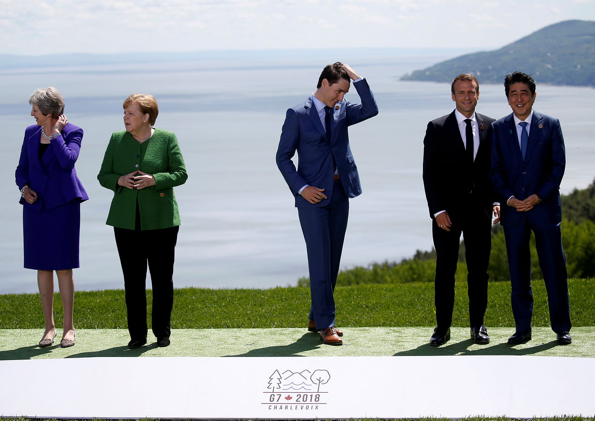 British prime minister Theresa May, German chancellor Angela Merkel, Canada`s prime minister Justin Trudeau, France`s president Emmanuel Macron and Japanese prime minister Shinzo Abe wait for US president Donald Trump to join them for a family photo at the G7 Summit in Charlevoix, Quebec, Canada, 8 June 2018. Photo: Reuters