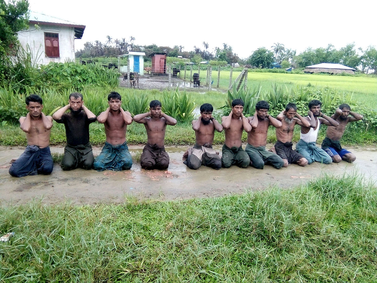 Ten Rohingya Muslim men with their hands bound kneel in Inn Din village, Myanmar, 1 September 2017. Photo: Reuters