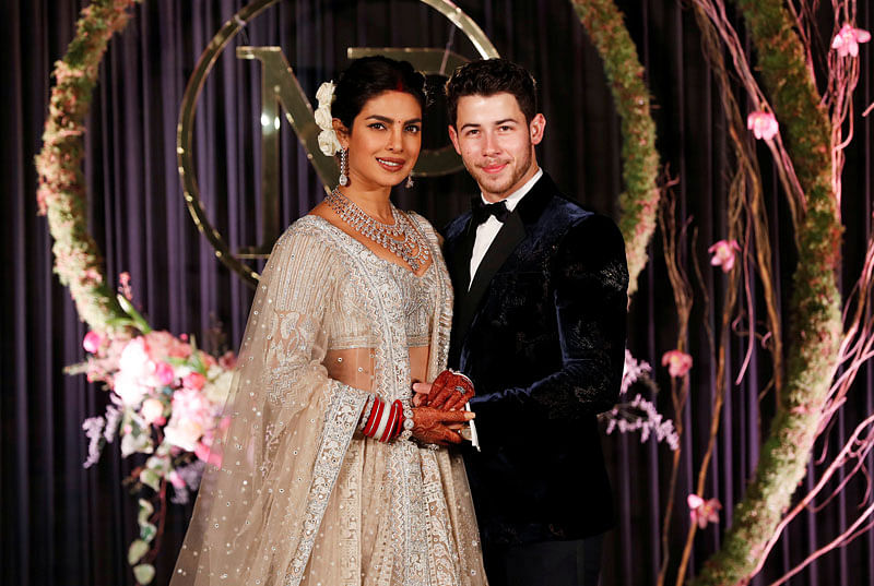 Bollywood actress Priyanka Chopra and her husband singer Nick Jonas pose during a photo opportunity at their wedding reception in New Delhi, India 4 December, 2018. Photo: Reuters