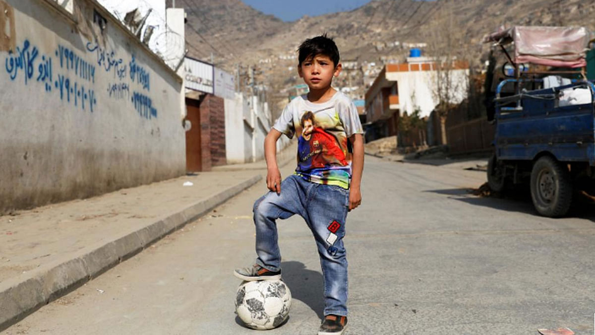 Murtaza Ahmadi, 7, an Afghan Lionel Messi fan, plays football outside his house in Kabul, Afghanistan on 8 December 2018. -- Photo: Reuters