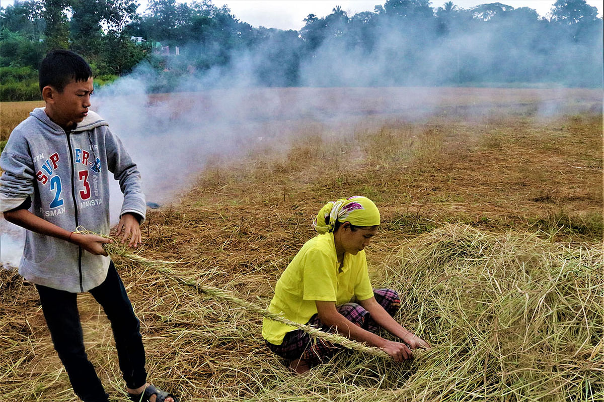 A mother and son making rope with hay at Monghor Residential High School area in Rangamati on 8 December. Photo: Supriya Chakma