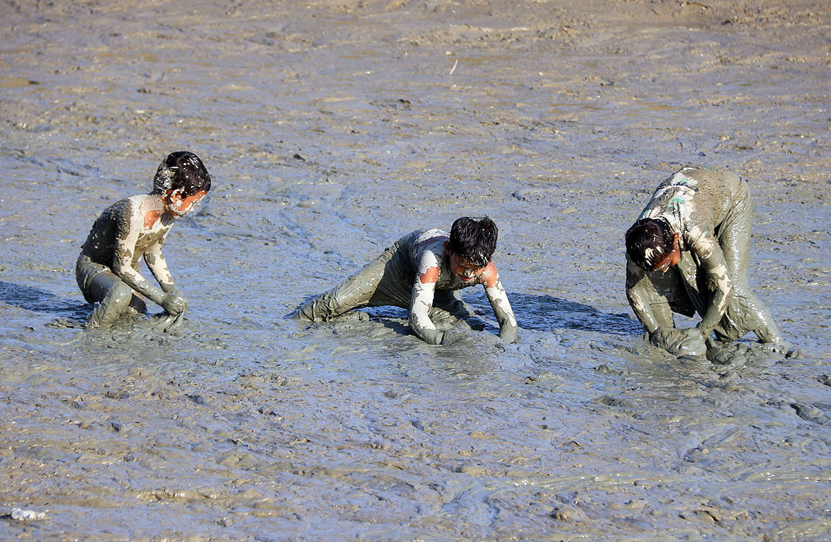 Children catching fish in the mud as the water is dried due to winter at Daulatpur, Cumilla on 8 December. Photo: Emdadul Haque