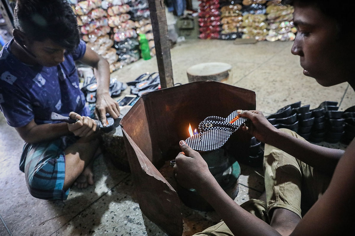 Two workers in a shoe factory in Kaptan Bazar, Dhaka. Shoes sell at Tk 150 to 300. A recent picture by Dipu Malakar