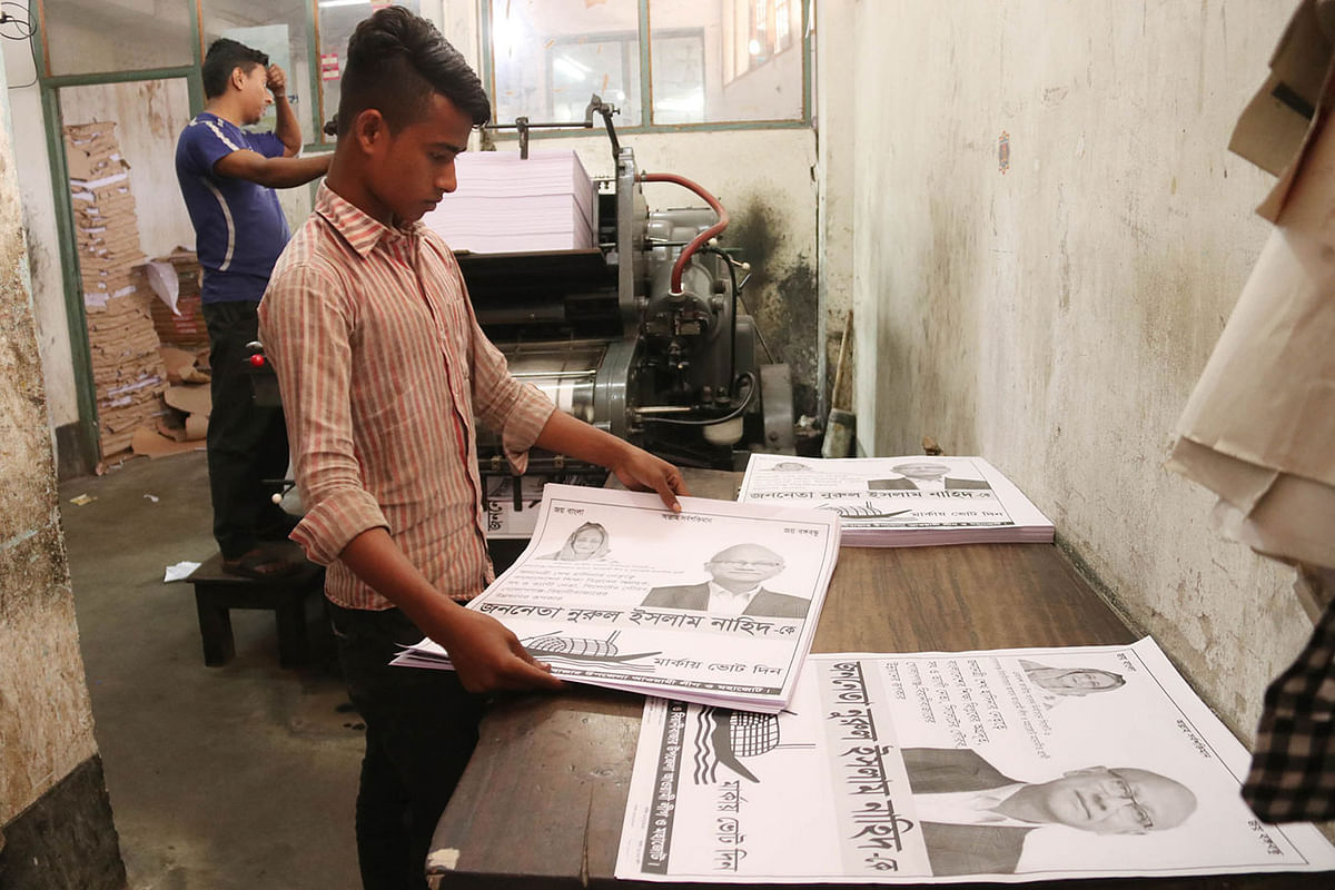 A worker sorts electoral posters in a press at Sandha Bazar in Sylhet on 9 January. Photo: Anis Mahmud
