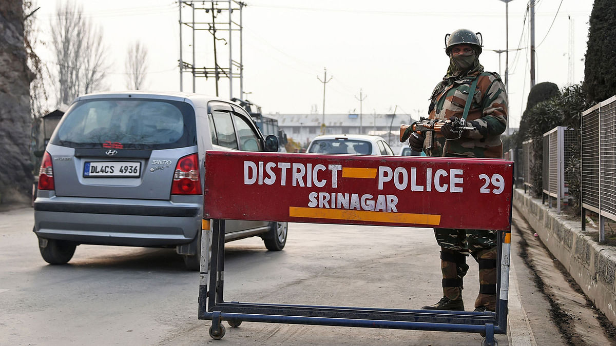 An Indian paramilitary trooper stands guard in Srinagar on 12 December, as security tightens following an attack on a police post at Zainpora village in southern Kashmir valley. Photo: AFP
