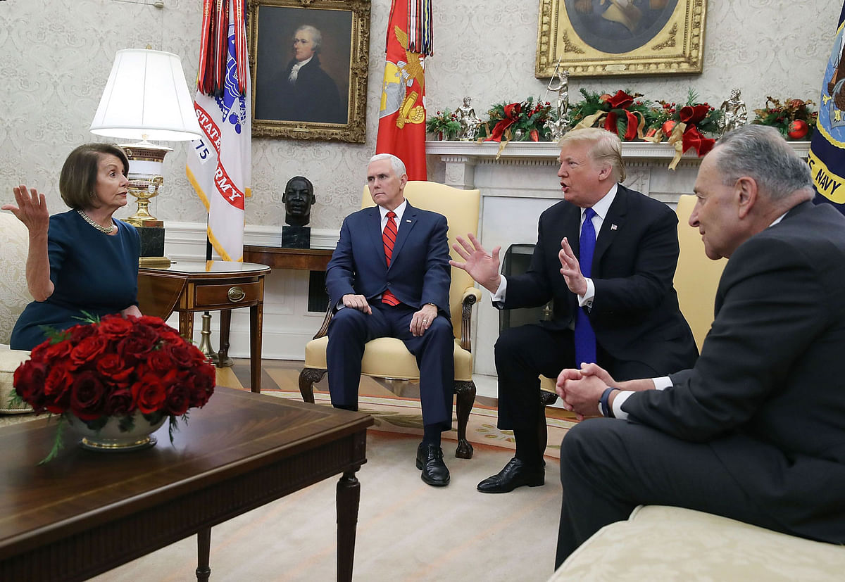 US president Donald Trump (2R) argues about border security with senate minority leader Chuck Schumer (D-NY) (R) and house minority leader Nancy Pelosi (D-CA) as vice president Mike Pence sits nearby in the Oval Office on 11 December, 2018 in Washington, DC. Photo: AFP