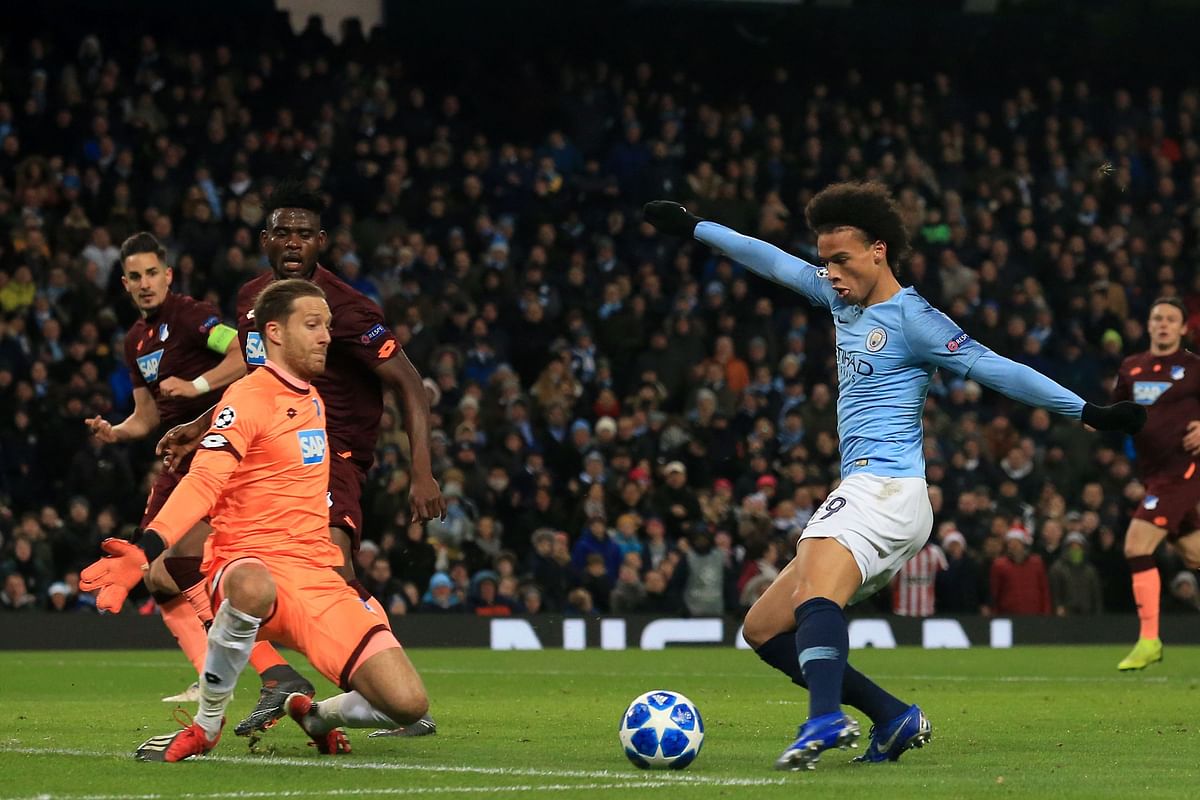 Manchester City`s German midfielder Leroy Sane (R) shoots past Hoffenheim`s German goalkeeper Oliver Baumann to score their second goal during the UEFA Champions League group F football match between Manchester City and Hoffenheim at the Etihad stadium in Manchester, north west England on December 12, 2018. AFP