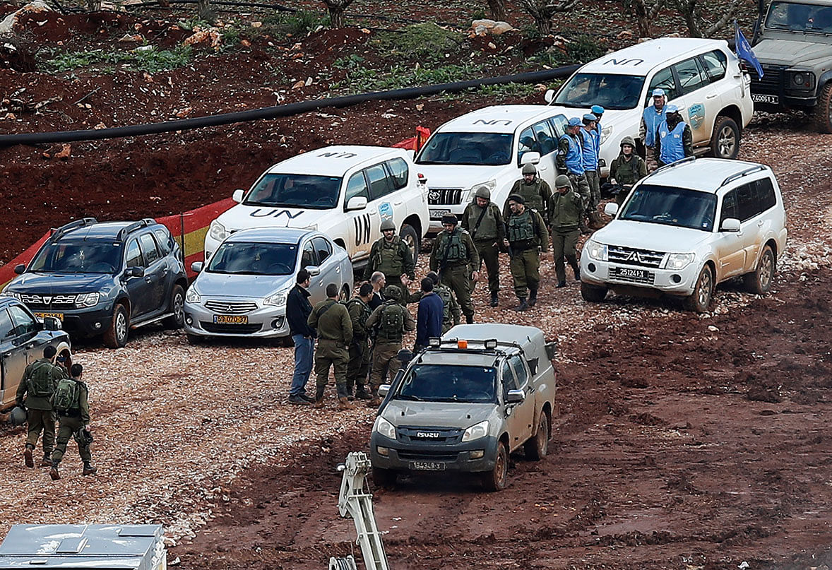 Israeli soldiers and UN peacekeepers gather at the site where the Israeli army works on the Lebanese-Israeli border in the southern village of Kafr Kila, Lebanon. Photo: AP