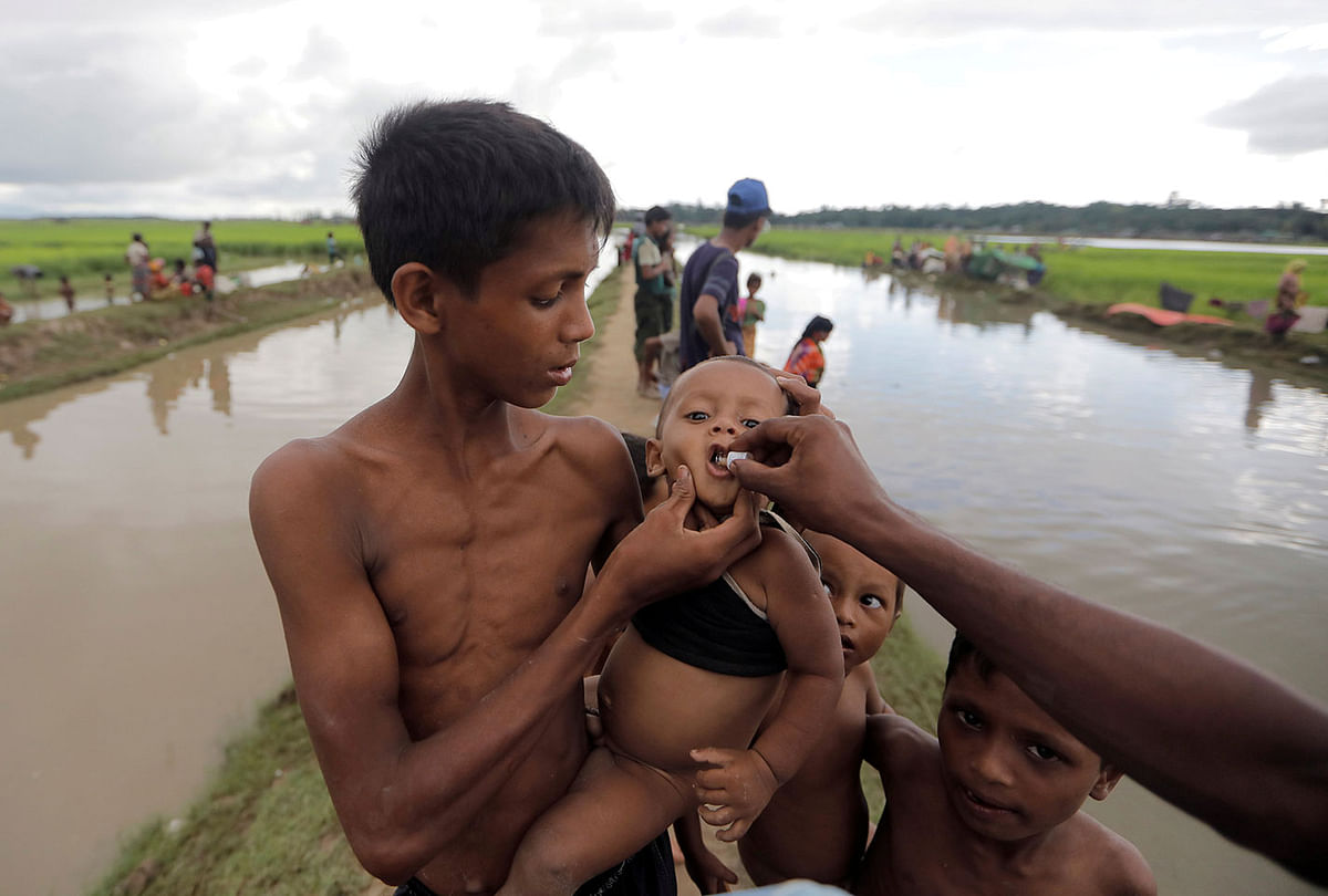 A Rohingya refugee boy who crossed the border from Myanmar a day before, gets an oral cholera vaccine, distributed by UNICEF workers as he waits to receive permission from the Bangladeshi army to continue his way to the refugee camps, in Palang Khali, near Cox`s Bazar, Bangladesh on 17 October 2017. Reuters File Photo