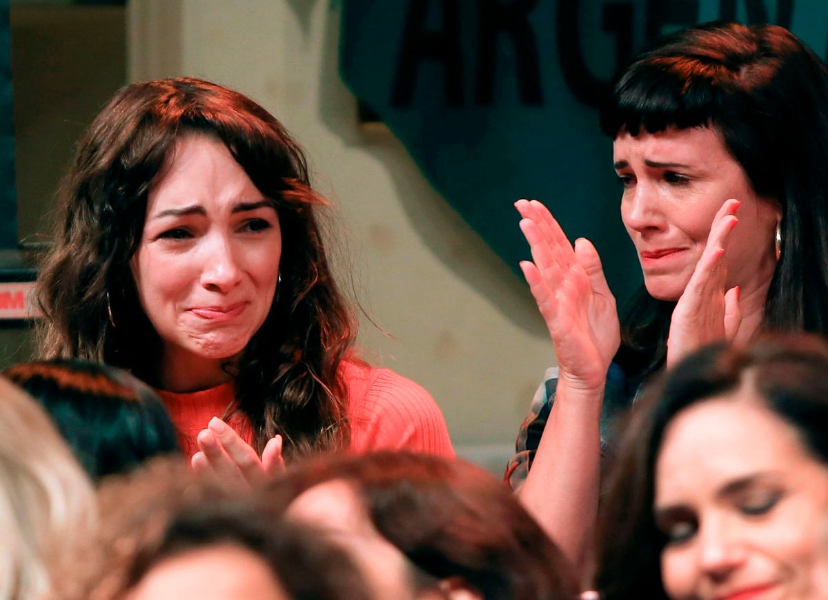 Argentine actresses Thelma Fardin (L) and Griselda Siciliani, members of the organization `Argentine Actresses` -against sexual abuse- react during a press conference in Buenos Aires on 11 December. File Photo