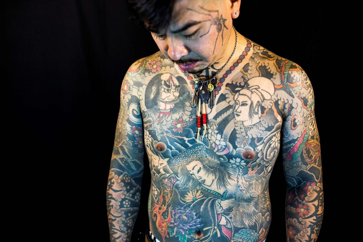 In this picture taken on 28 October 2017, Japanese tattoo artist Horitatsu displays his tattoos as he poses for a photo at his studio in Tsurugashima, Saitama prefecture. Photo: AFP