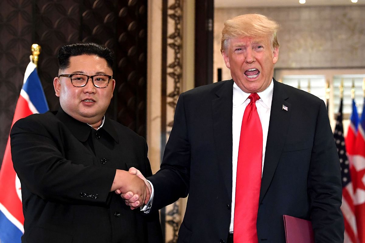 In this file photo taken on 12 June 2018, US president Donald Trump (R) and North Korea`s leader Kim Jong Un shake hands following a signing ceremony during their historic US-North Korea summit, at the Capella Hotel on Sentosa island in Singapore. Photo: AFP