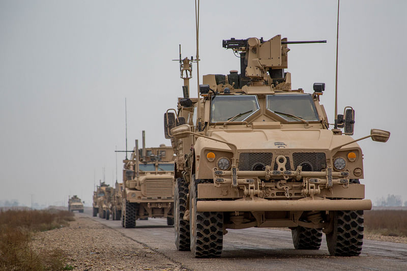 A Coalition convoy of US led international coalition against the Islamic State of Iraq and the Levant (ISIL) stops to test fire their M2 machine guns and MK19 grenade launcher in the Middle Euphrates River Valley in the Deir ez-Zor province, Syria, 22 November 2018. Photo: Reuters