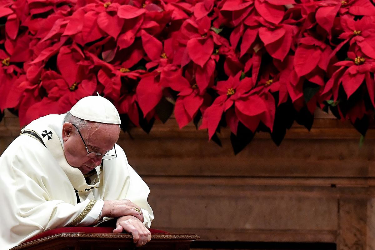 Pope Francis prays as he celebrates the Christmas mass marking the birth of Jesus Christ on 24 December 2018 at St Peter`s basilica in Vatican. Photo: AFP