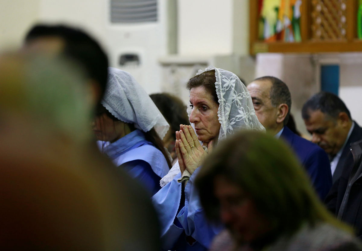 Iraqi Christians pray during a mass on Christmas at St George Chaldean Catholic Church in Baghdad, Iraq on 25 December 2018. Photo: Reuters